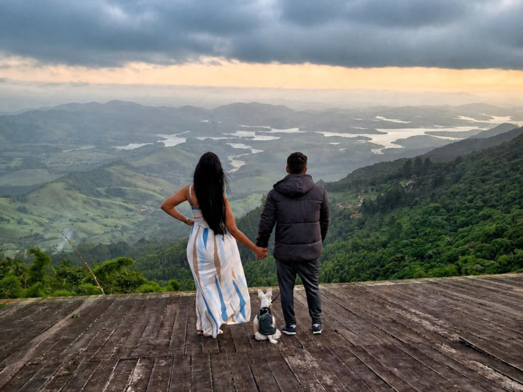 Casal com cachorro observa a paisagem, simbolizando construção de patrimônio e liberdade financeira.